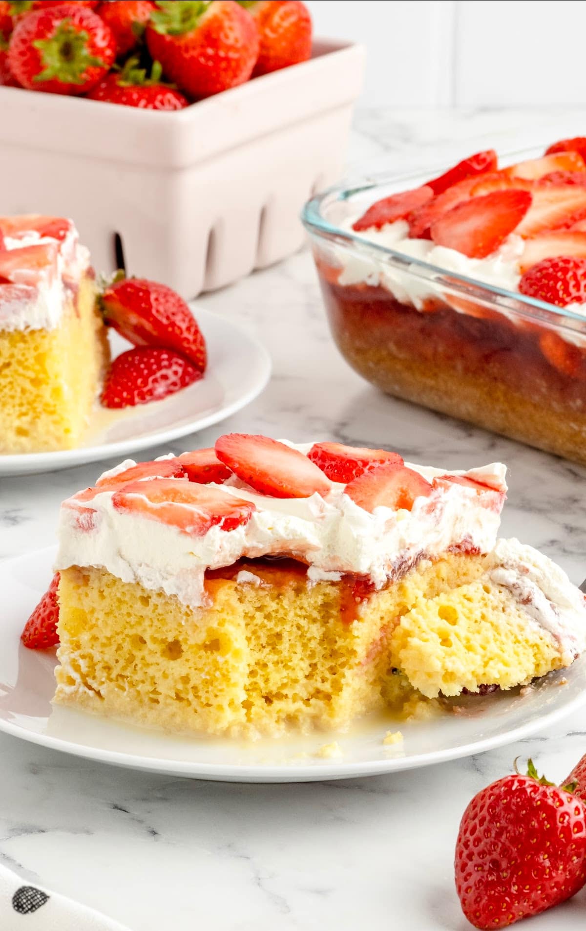 a plate served with a piece of Strawberry Tres Leches Cake