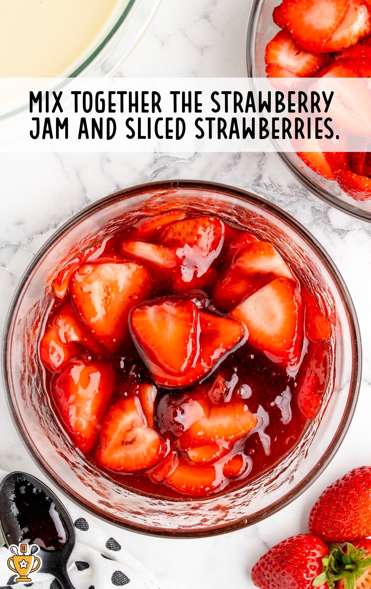 strawberry jam and sliced strawberries in a bowl