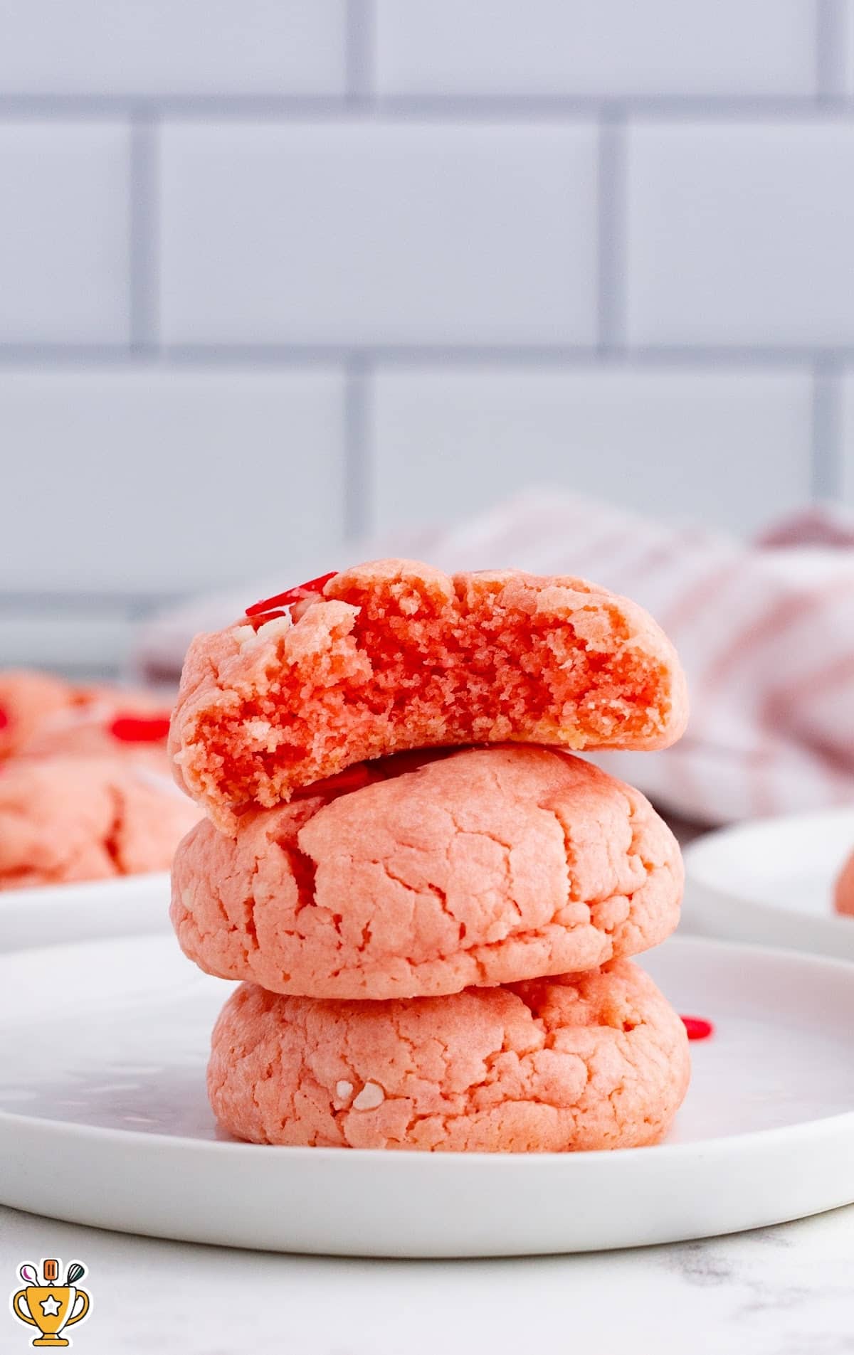 A stack of Valentine Cookies and one has a bite out of it.