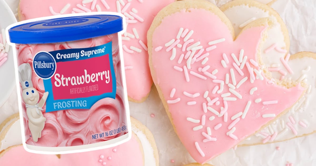 Valentine Sugar Cookie with a bite on it with a can of frosting on the side