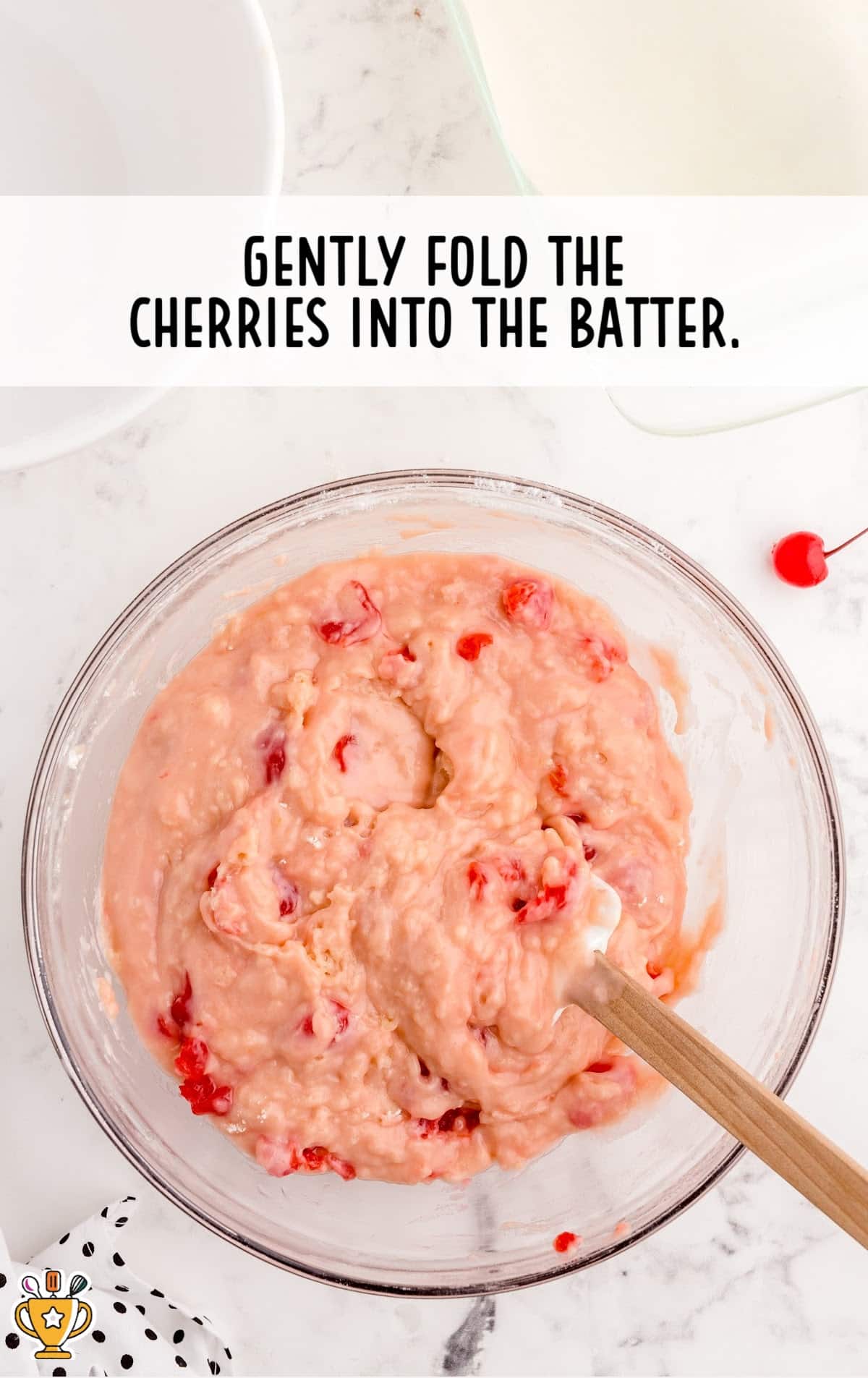 cherries folded in batter in a bowl