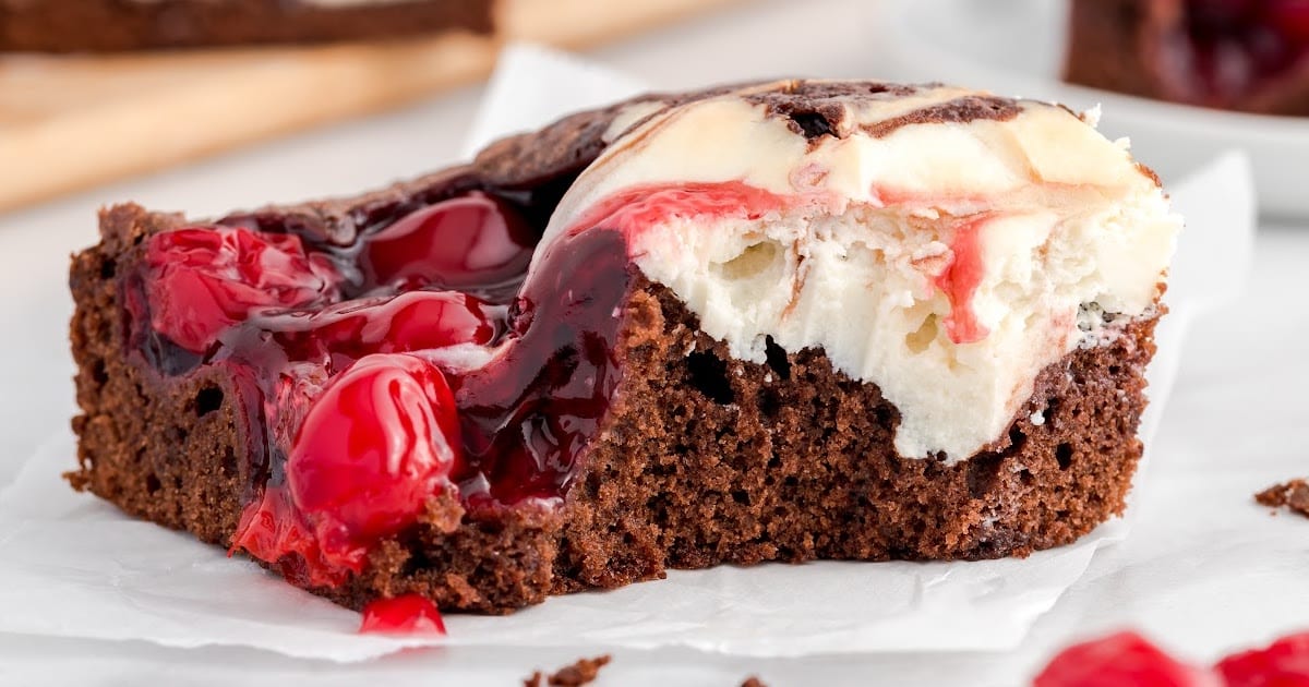 A Cherry Cheesecake Brownie on a piece of parchment.