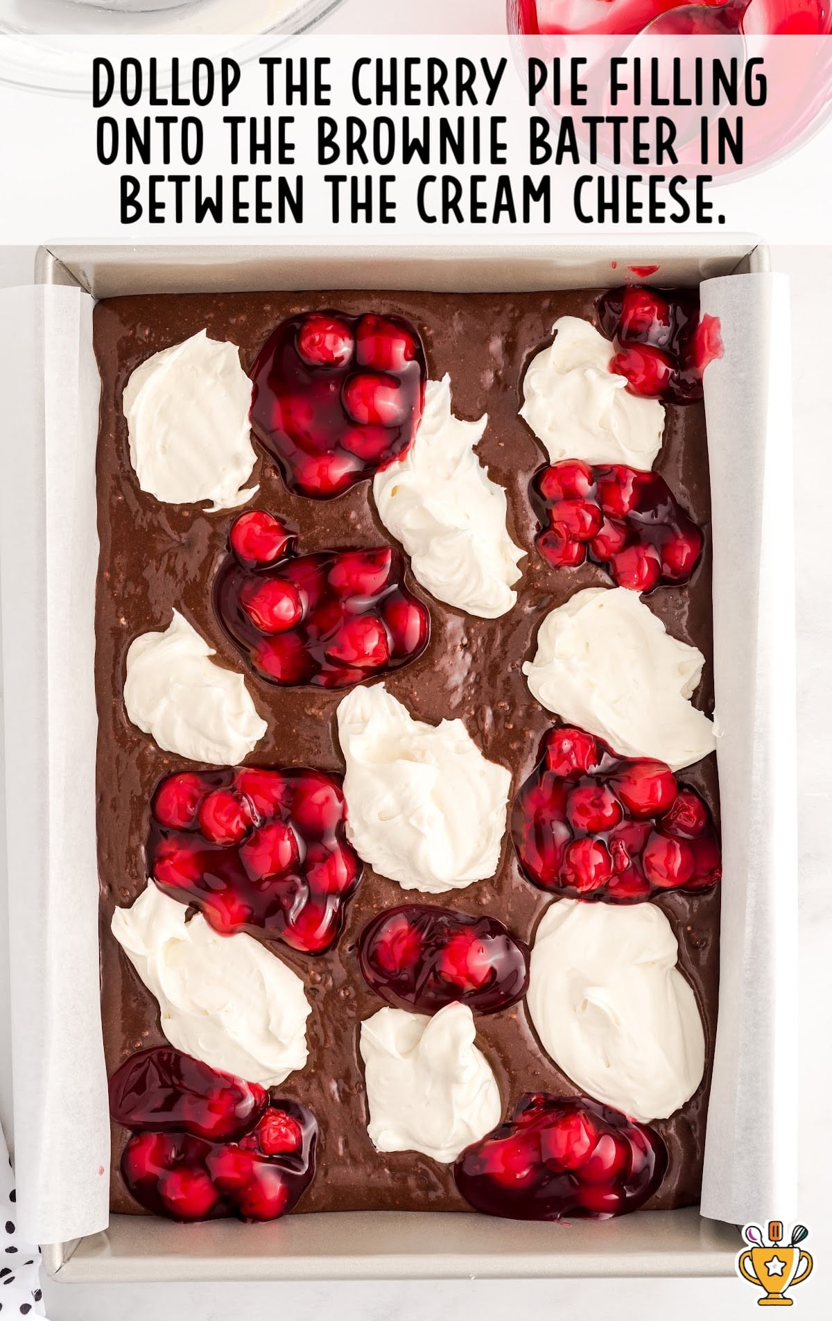 Cherry pie fiing is on top of the brownie batter.
