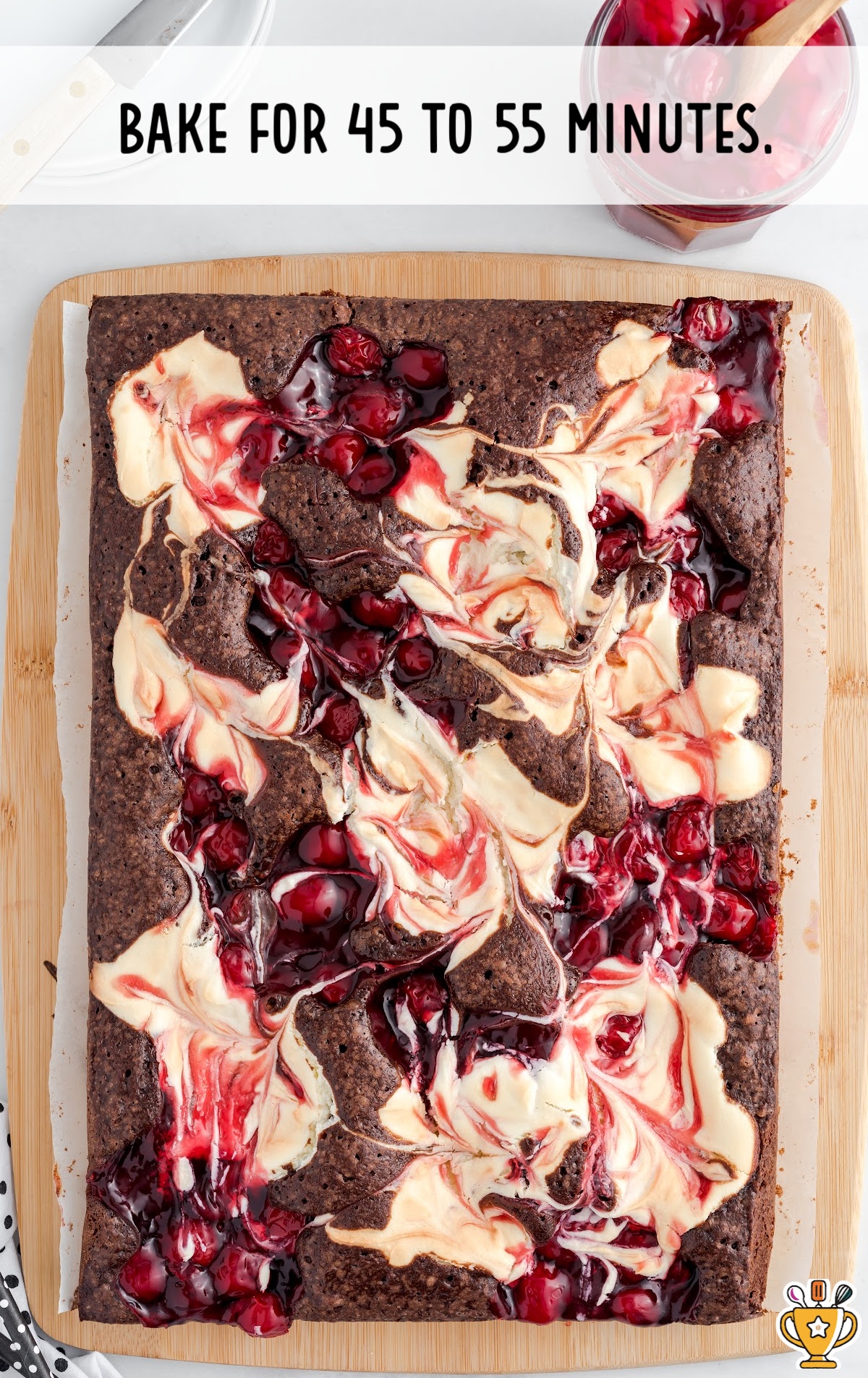 A baked Cherry Cheesecake Brownie on a cutting board.