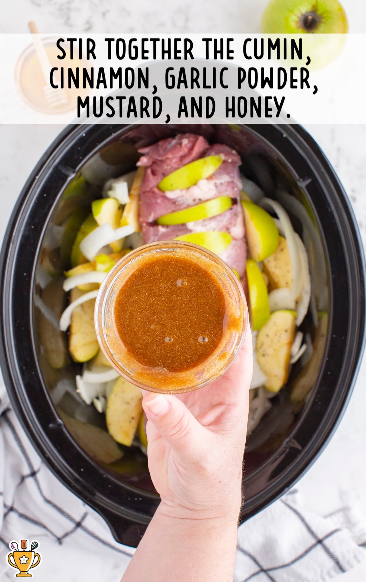 stirring together the cumin, cinnamon, garlic powder, mustard and honey in a crockpot