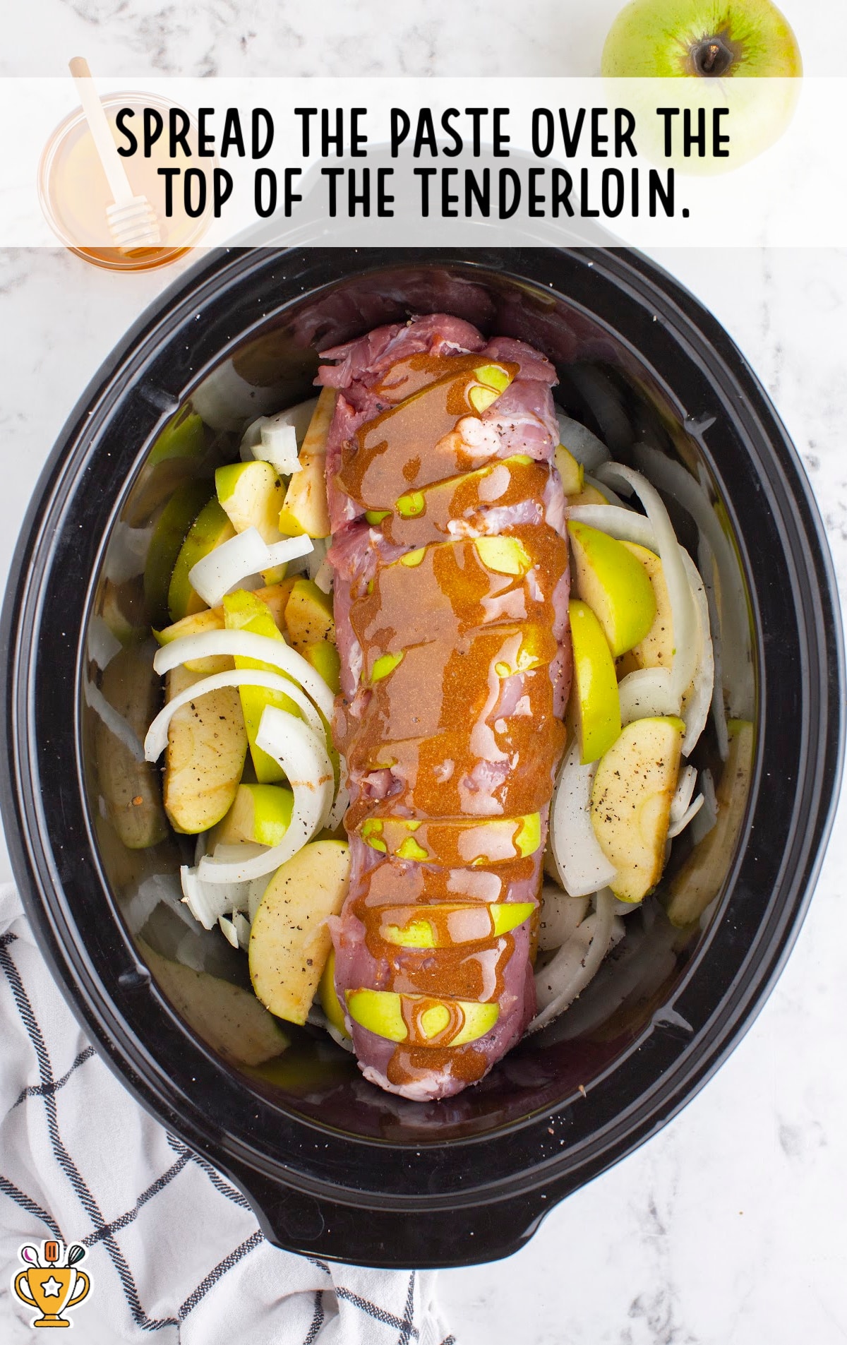 spreading the paste over the top of the tenderloin in the crockpot