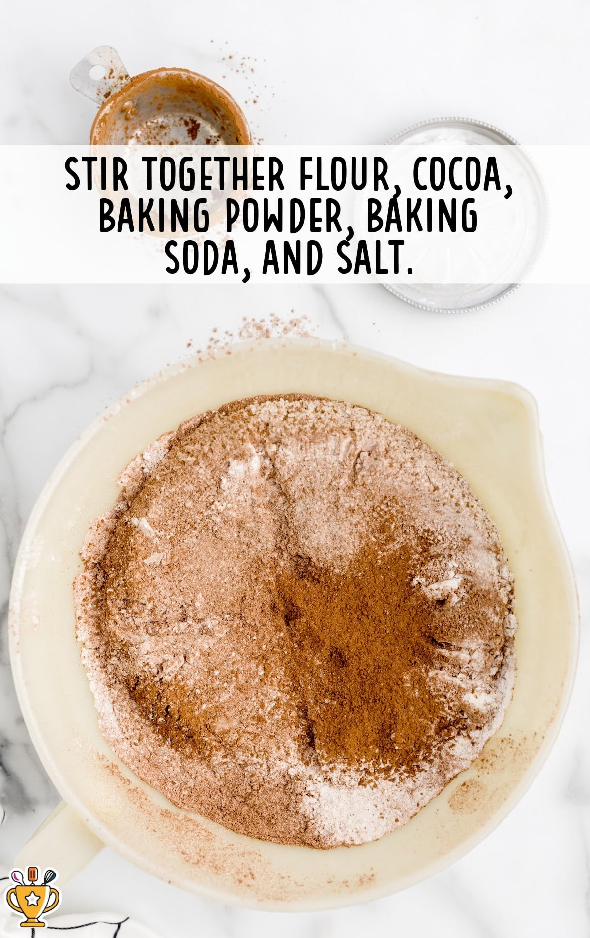 flour, cocoa, baking powder, baking soda and salt added in a bowl