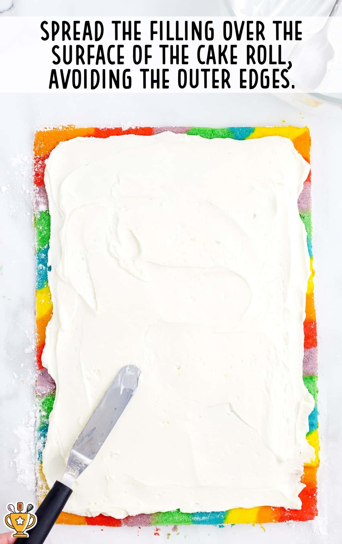 spreading the filling over the surface of the cake roll
