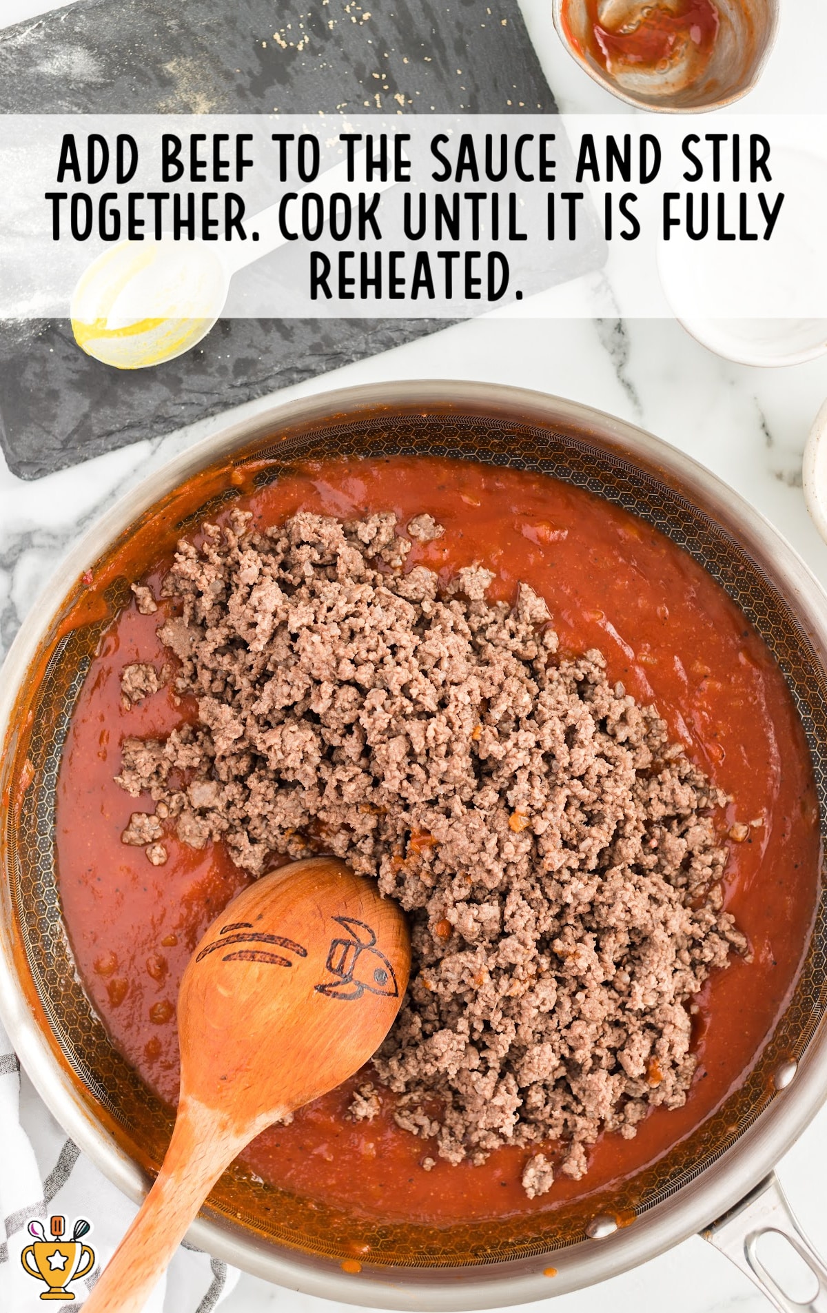 beef added to the sauce and stirred together in a frying pan