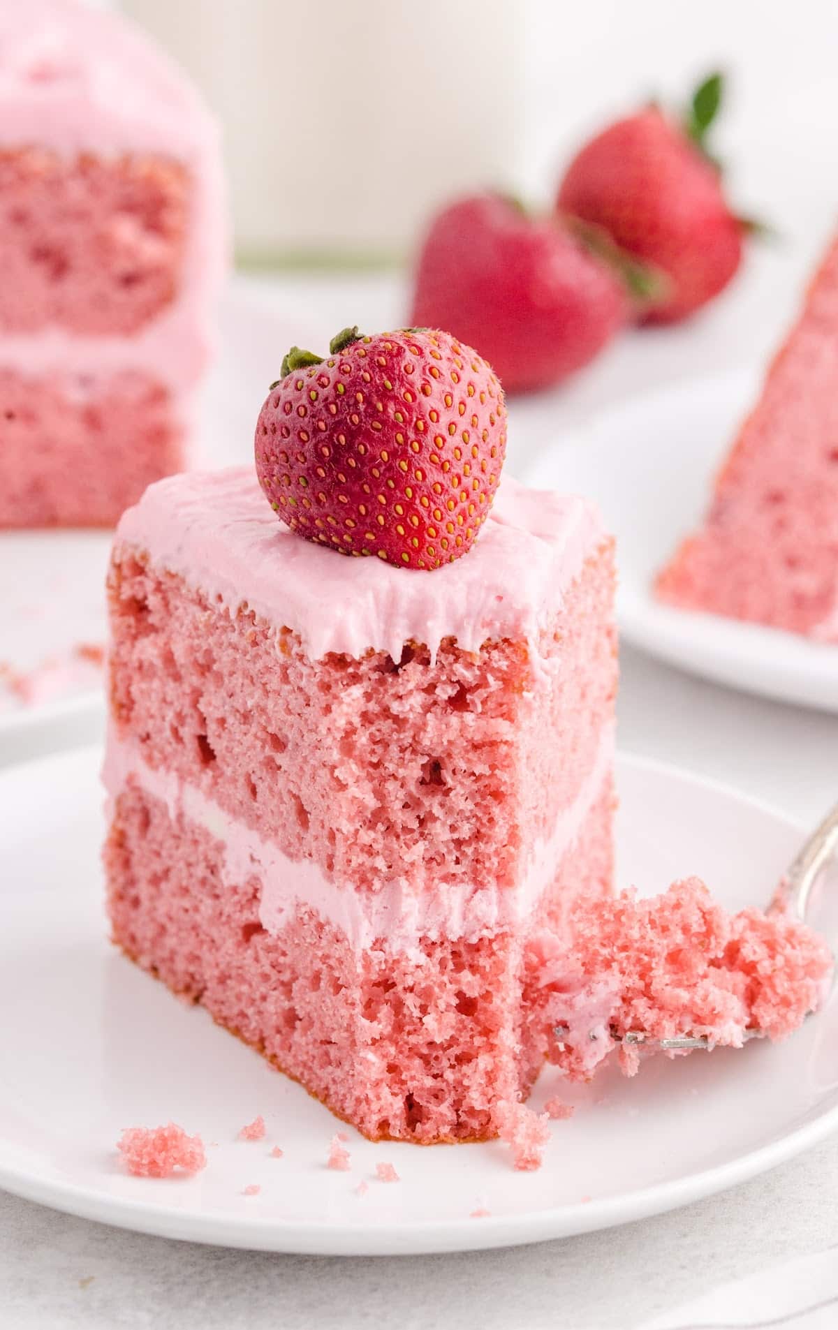 a piece of Strawberry Cake on a white dessert plate