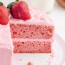 a Strawberry Cake with a cut piece
