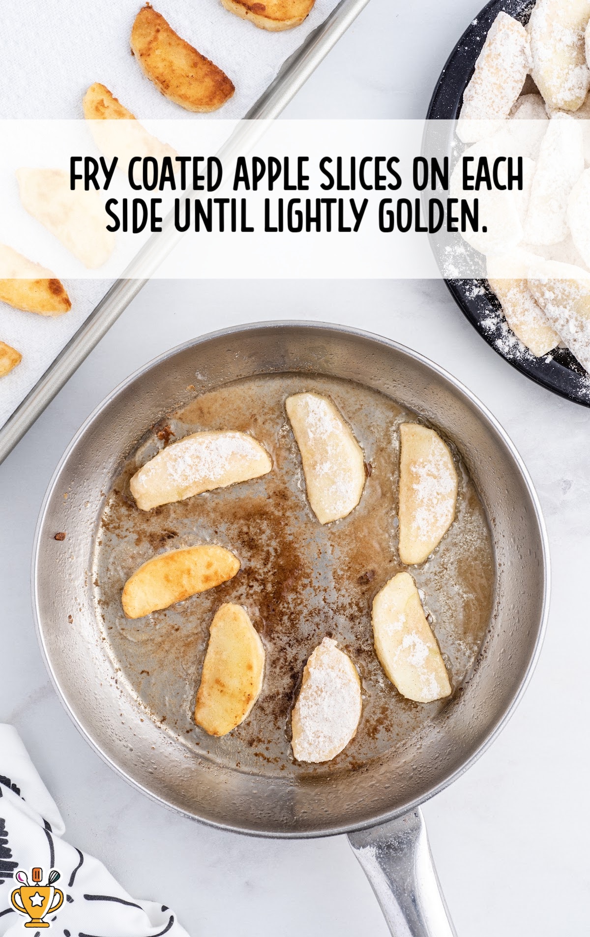coated apple slices in a frying pan