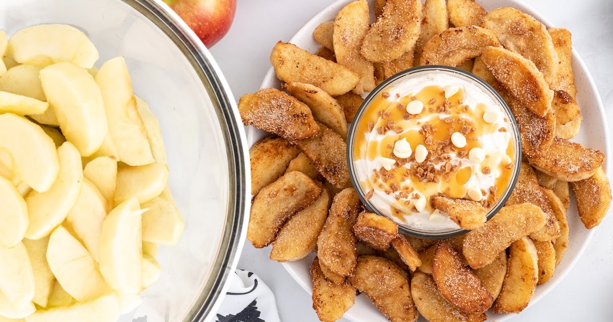 Apple Fries on a plate with a bowl of sauce at the middle of the fries and some uncooked apple slices in a bowl on the side