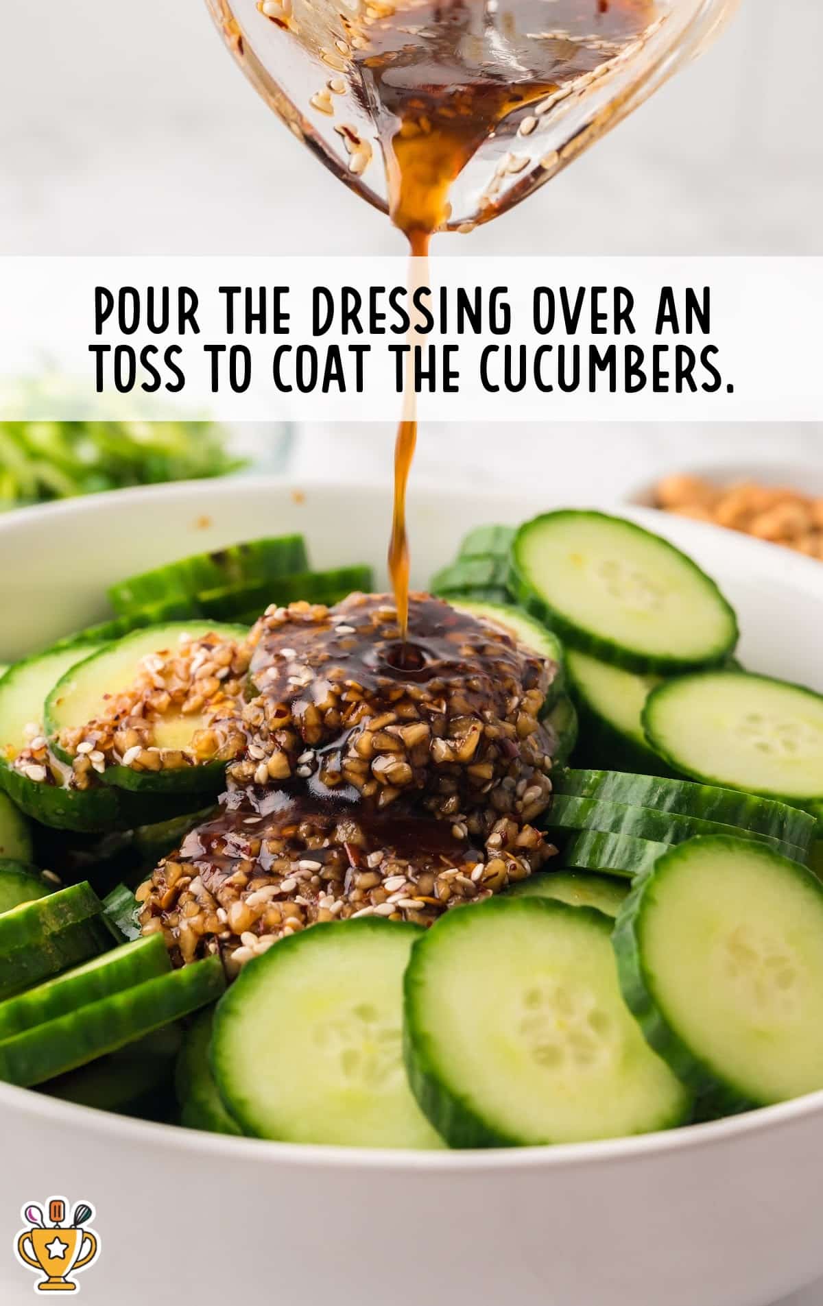 pouring dressing over Asian Cucumber Salad in a bowl