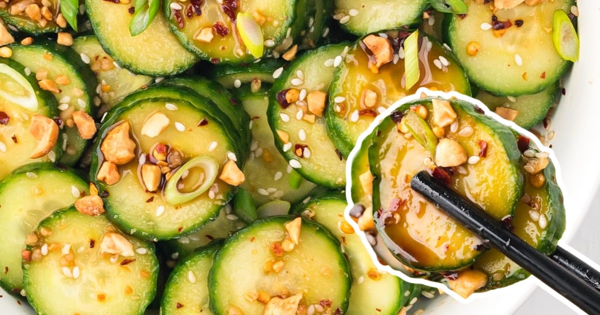 two chopsticks holding some Asian Cucumber Salad and some more in a white bowl