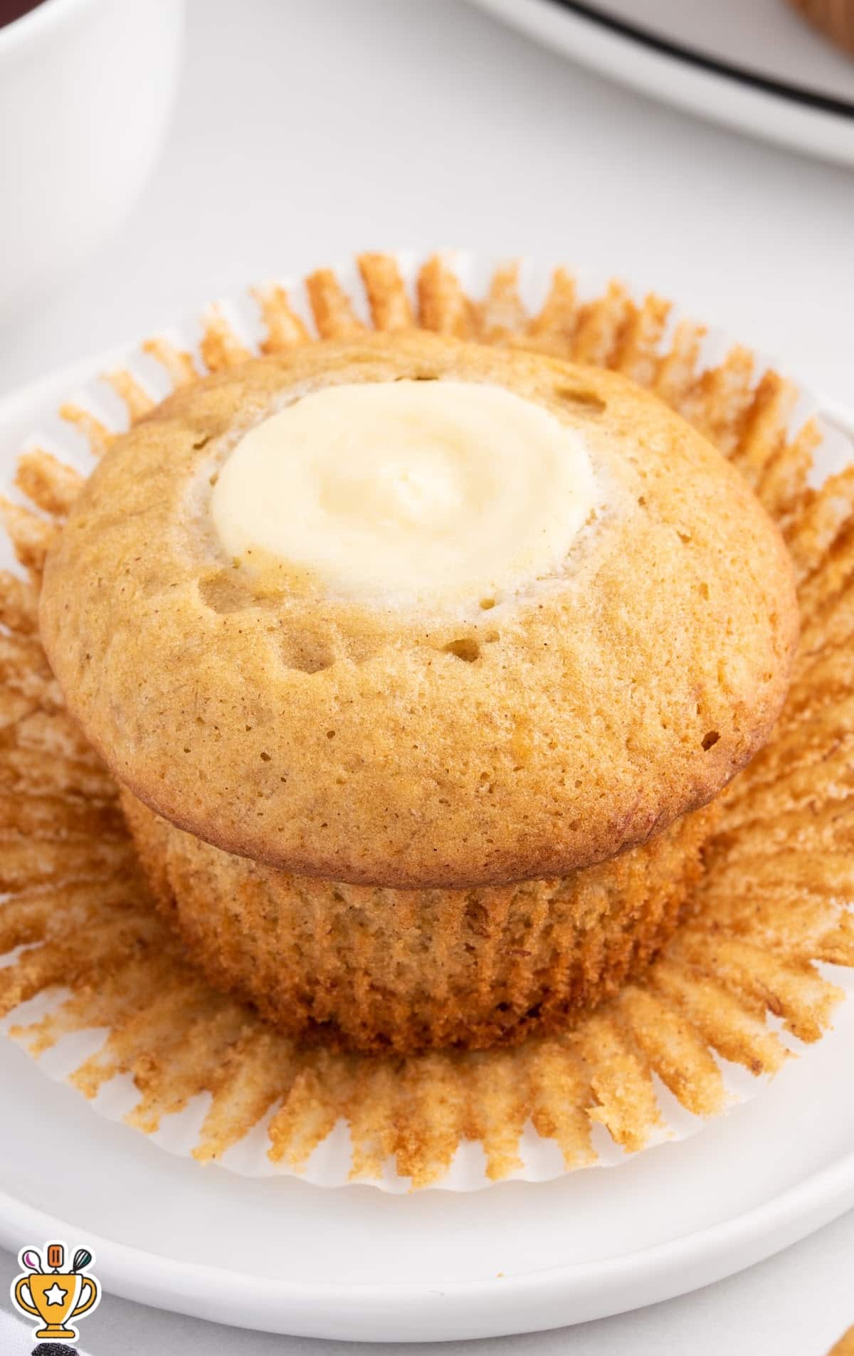 a Banana Cream Cheese Muffin on a white plate