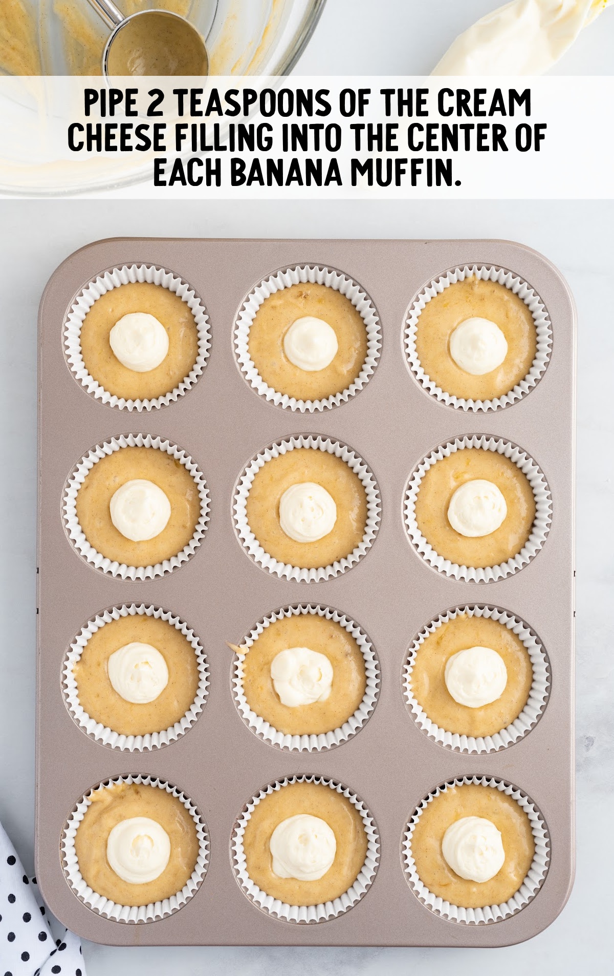 cream cheese filling piped into the center of each banana muffin