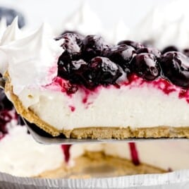 a spatula holding a piece of Blueberry Cream Cheese Pie
