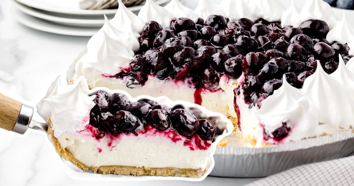 a spatula holding a piece of Blueberry Cream Cheese Pie
