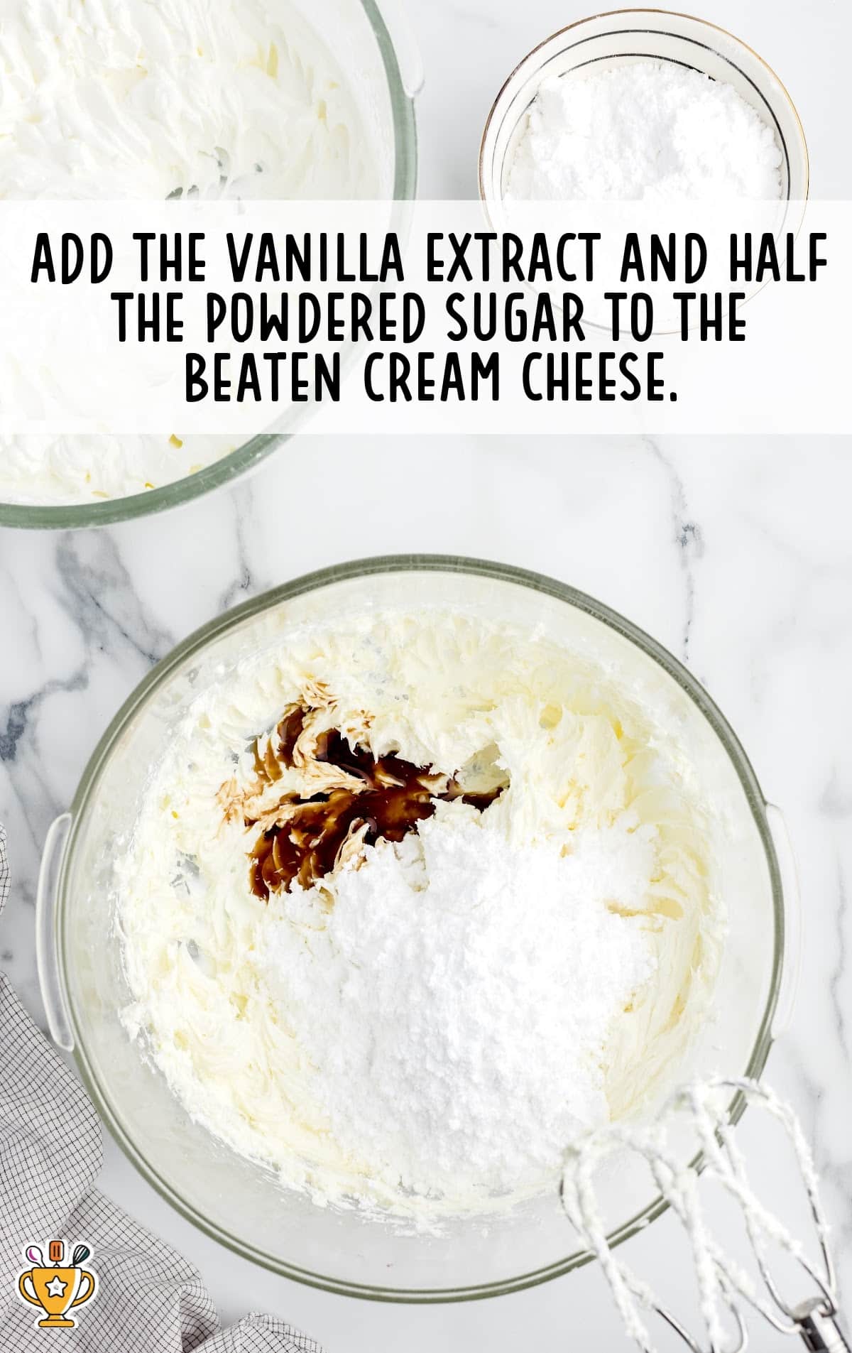 adding vanilla extract and half the powdered sugar to the beaten cream cheese