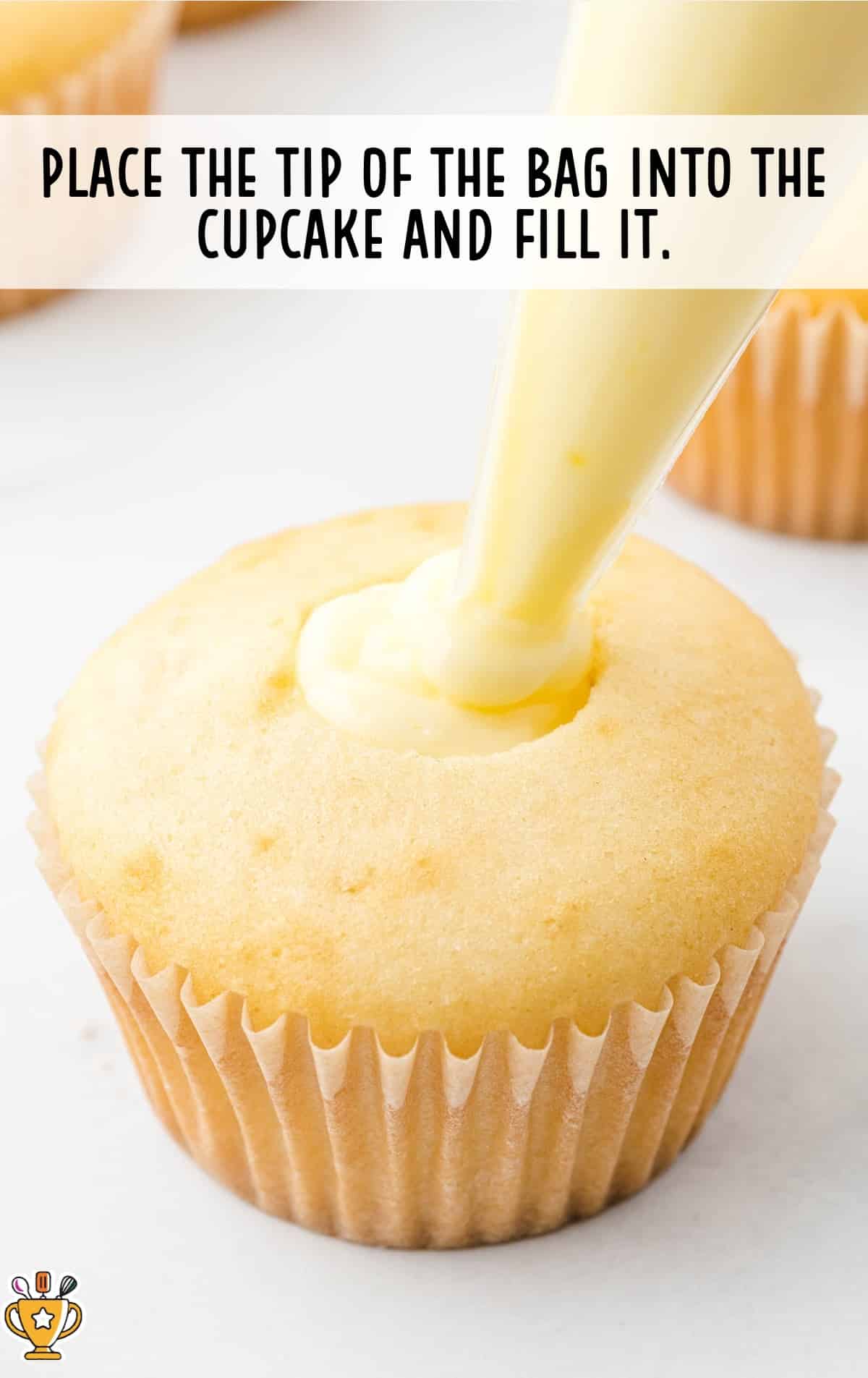 the tip of the bag placed into the cupcake