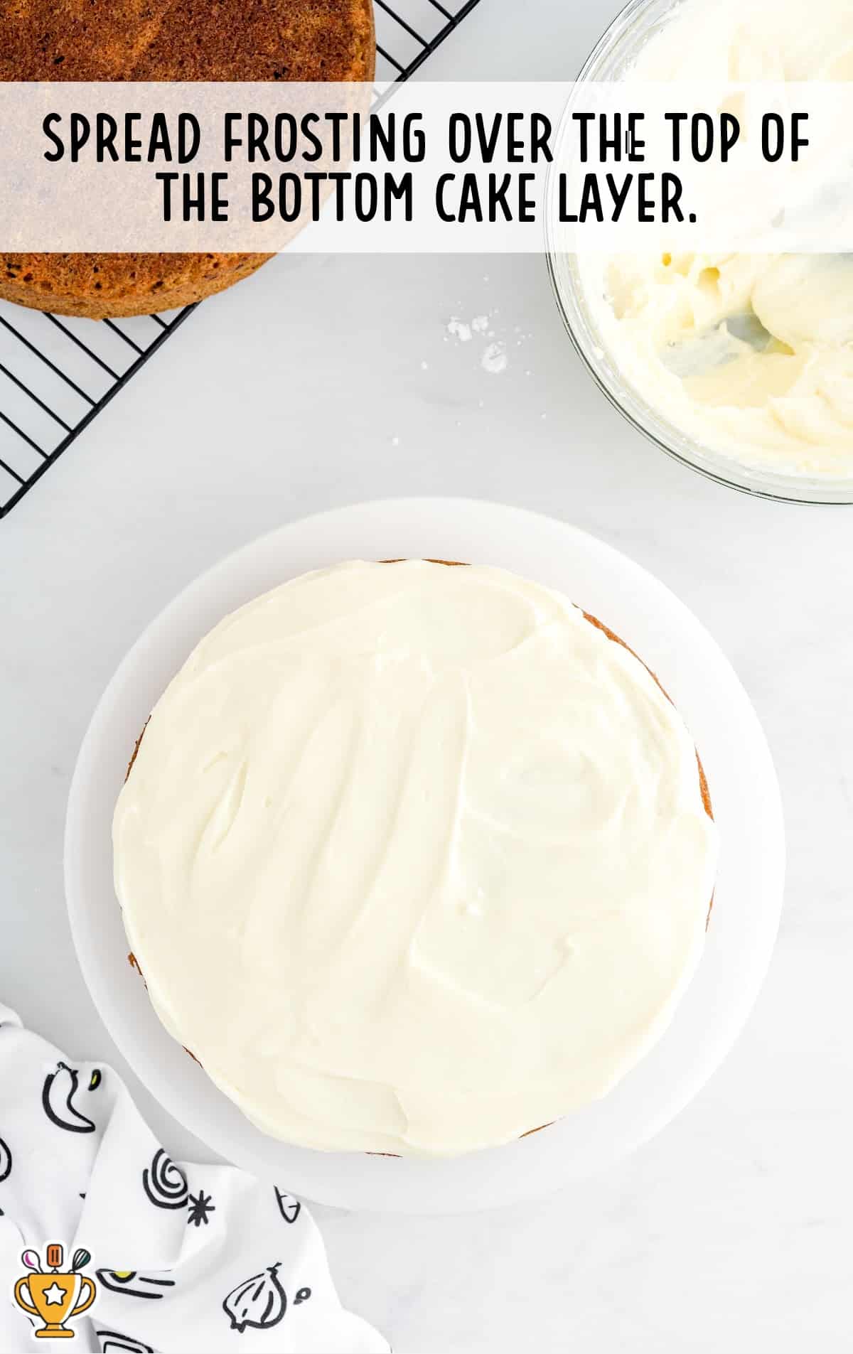 frosting spread over the top of the bottom cake layer