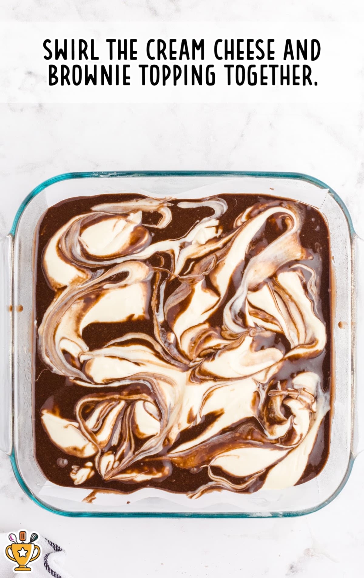 cream cheese and brownie topping swirled together in a baking dish