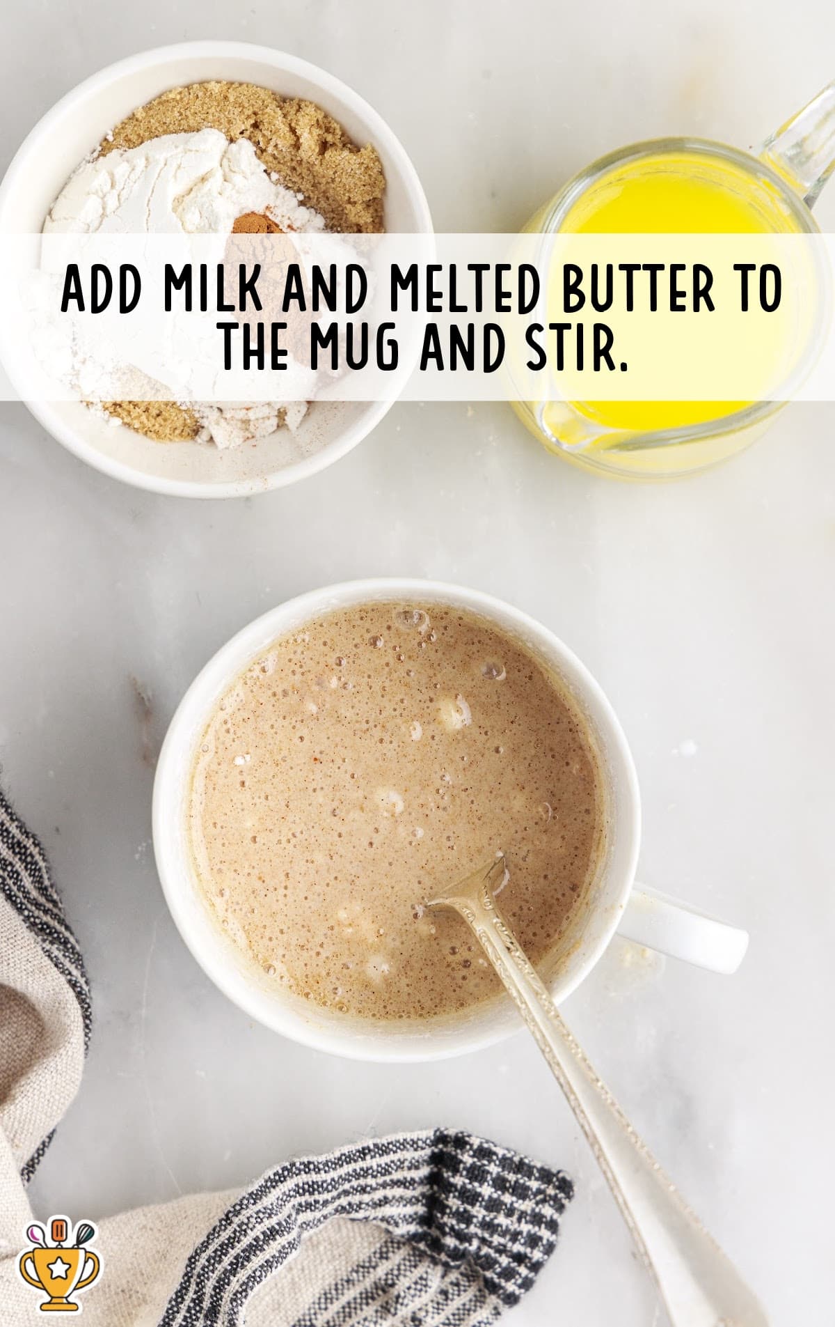 milk and melted butter added in a mug and stirred