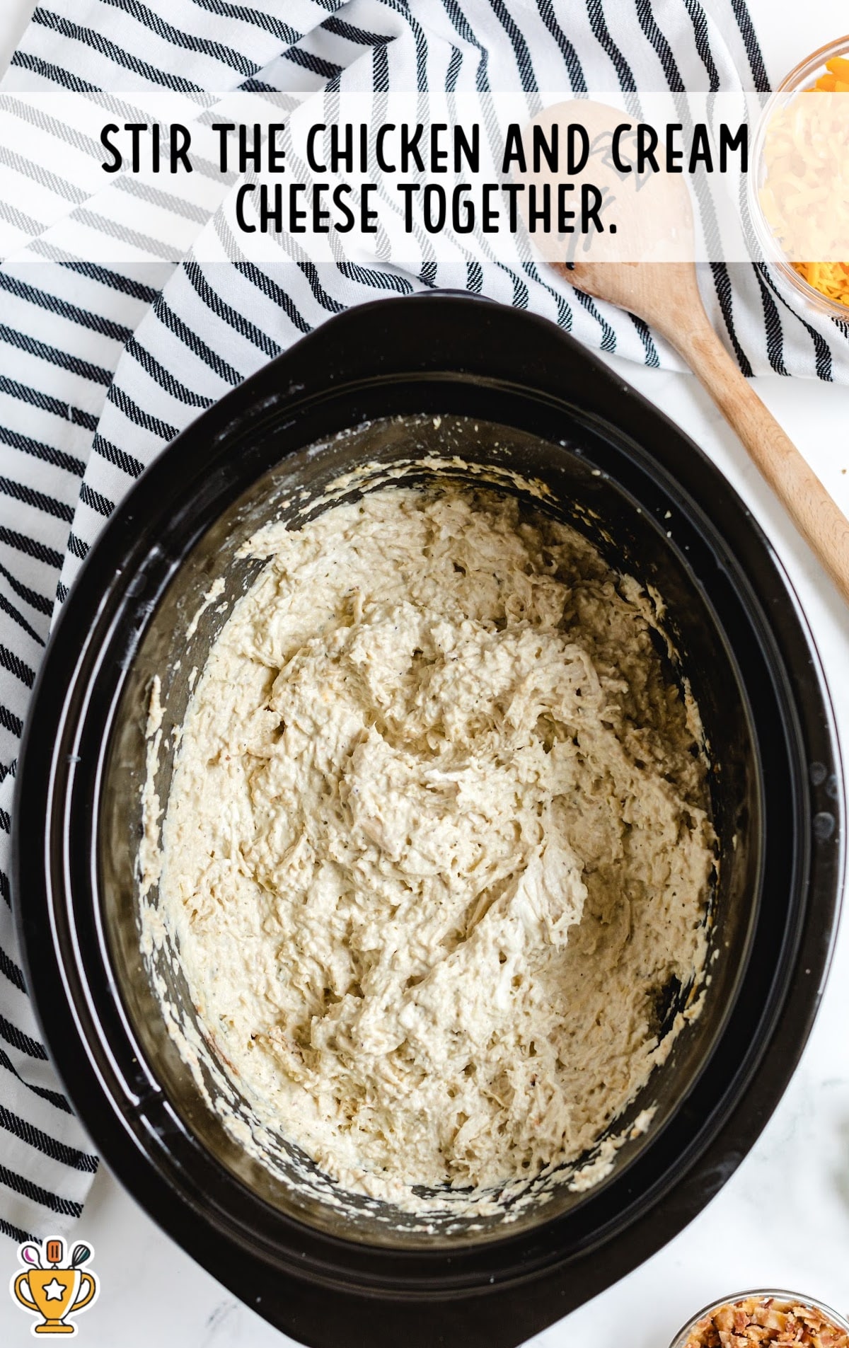 chicken and cream cheese stirred together in a crockpot