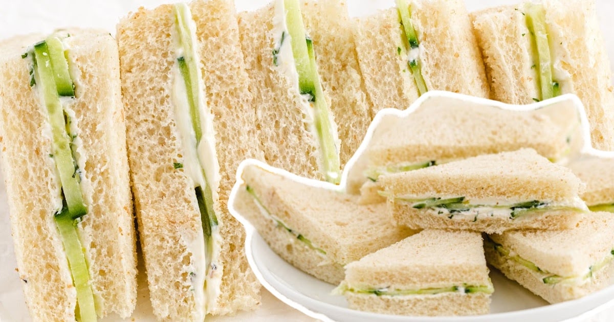 Cucumber Sandwiches on a plate and a bunch of Cucumber Sandwiches at the back