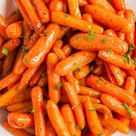 Glazed Carrots on a plate with a spoon in it