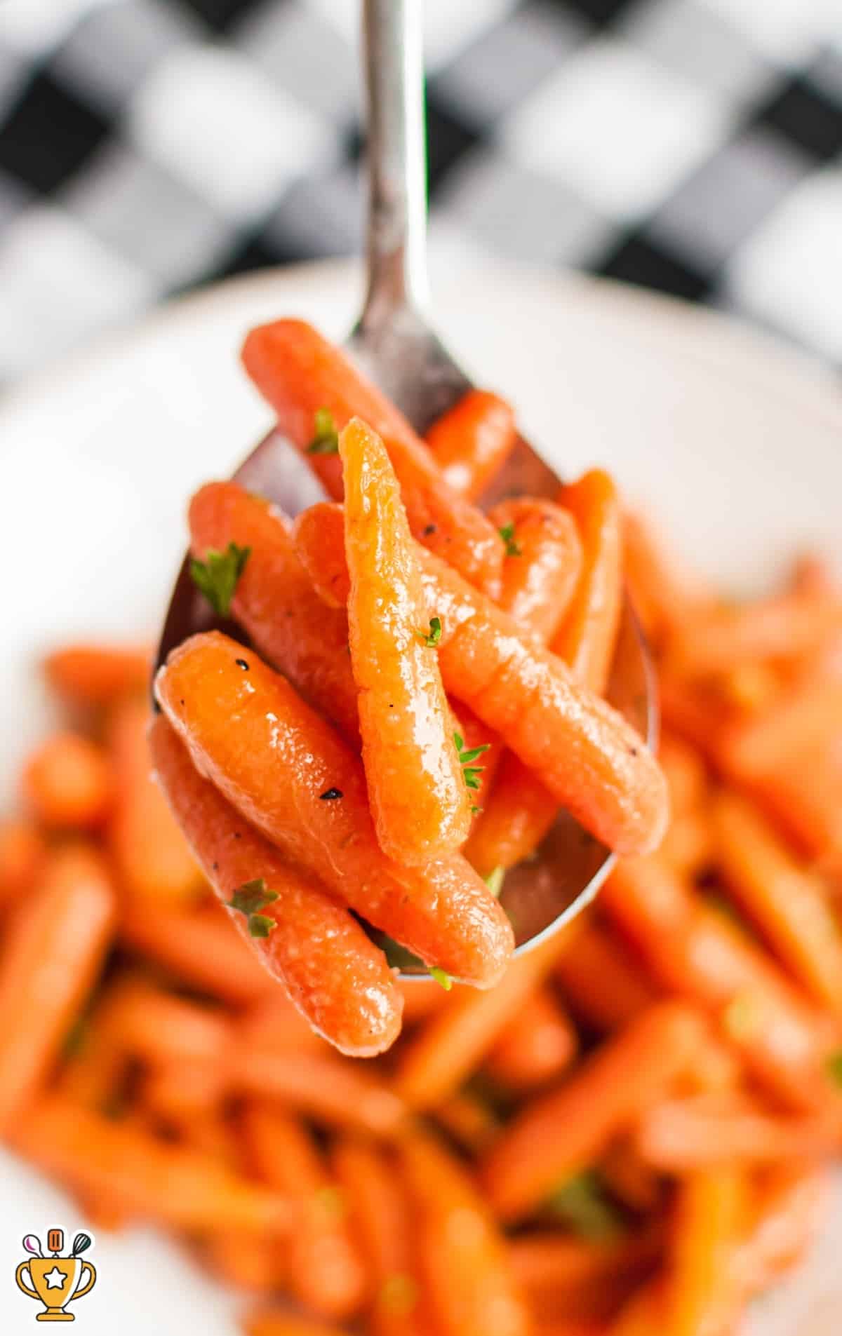 a spoon holding some Glazed Carrots