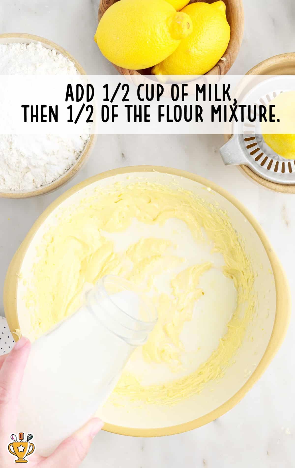 pouring milk in a bowl of flour mixture