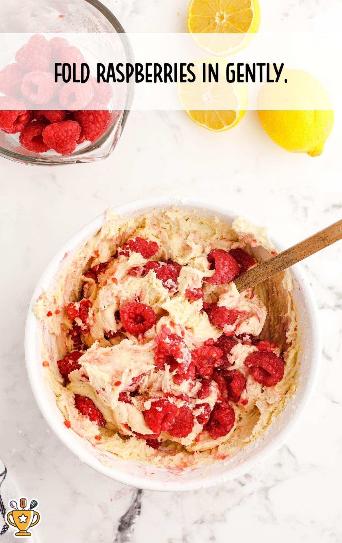 raspberries mixed with the dough in a white bowl