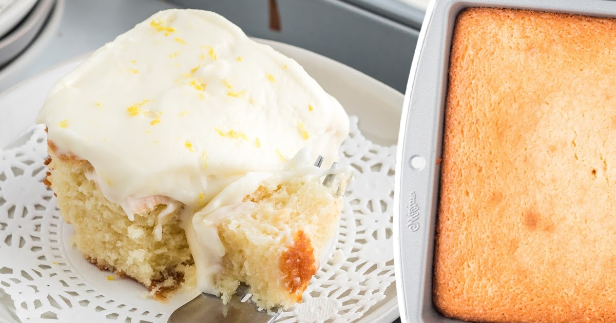 a piece of Lemon Sour Cream Cake on a plate with a fork holding some of it, a Lemon Sour Cream Cake in a baking pan on the side