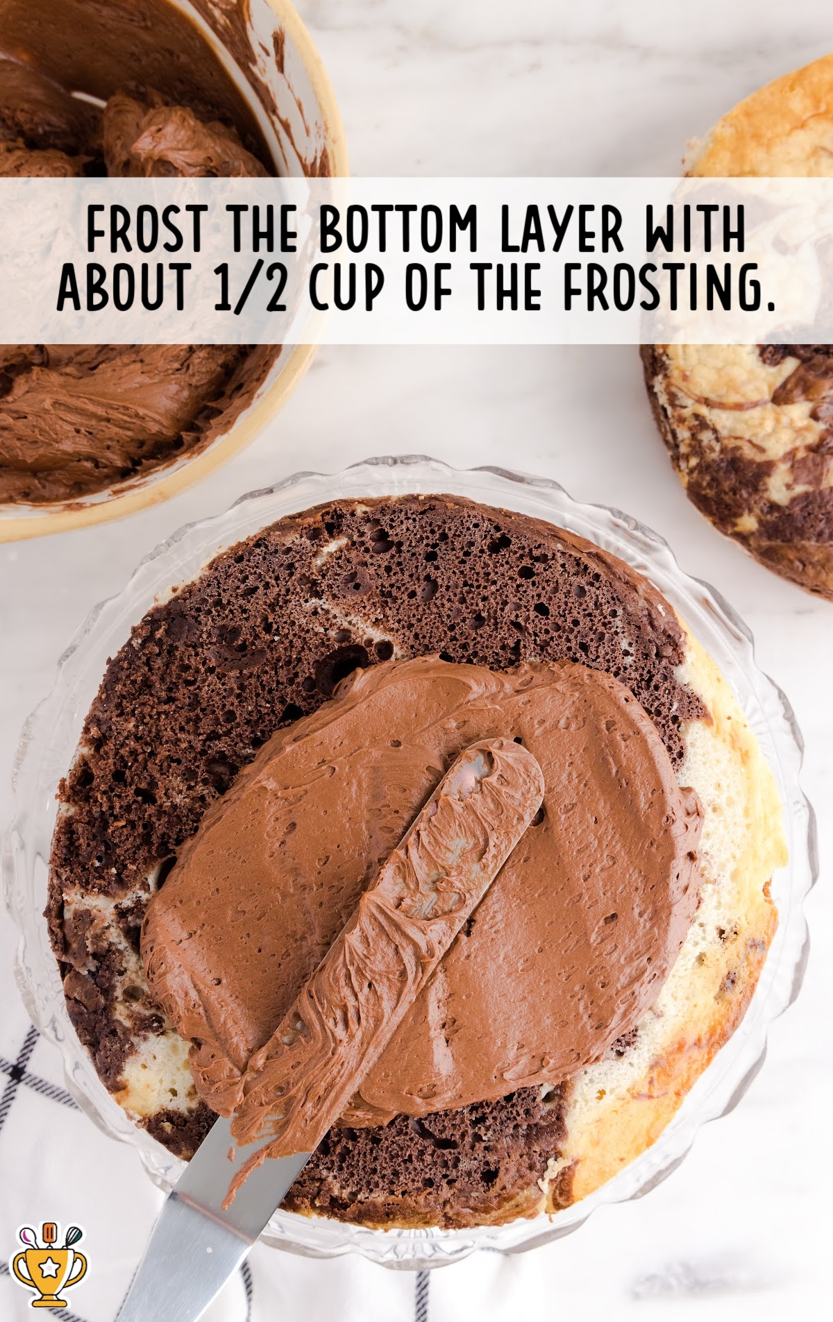 placing frosting on top of the cake