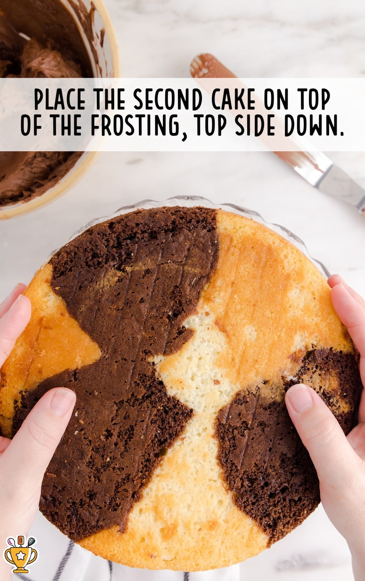 second cake placed on top of the topping