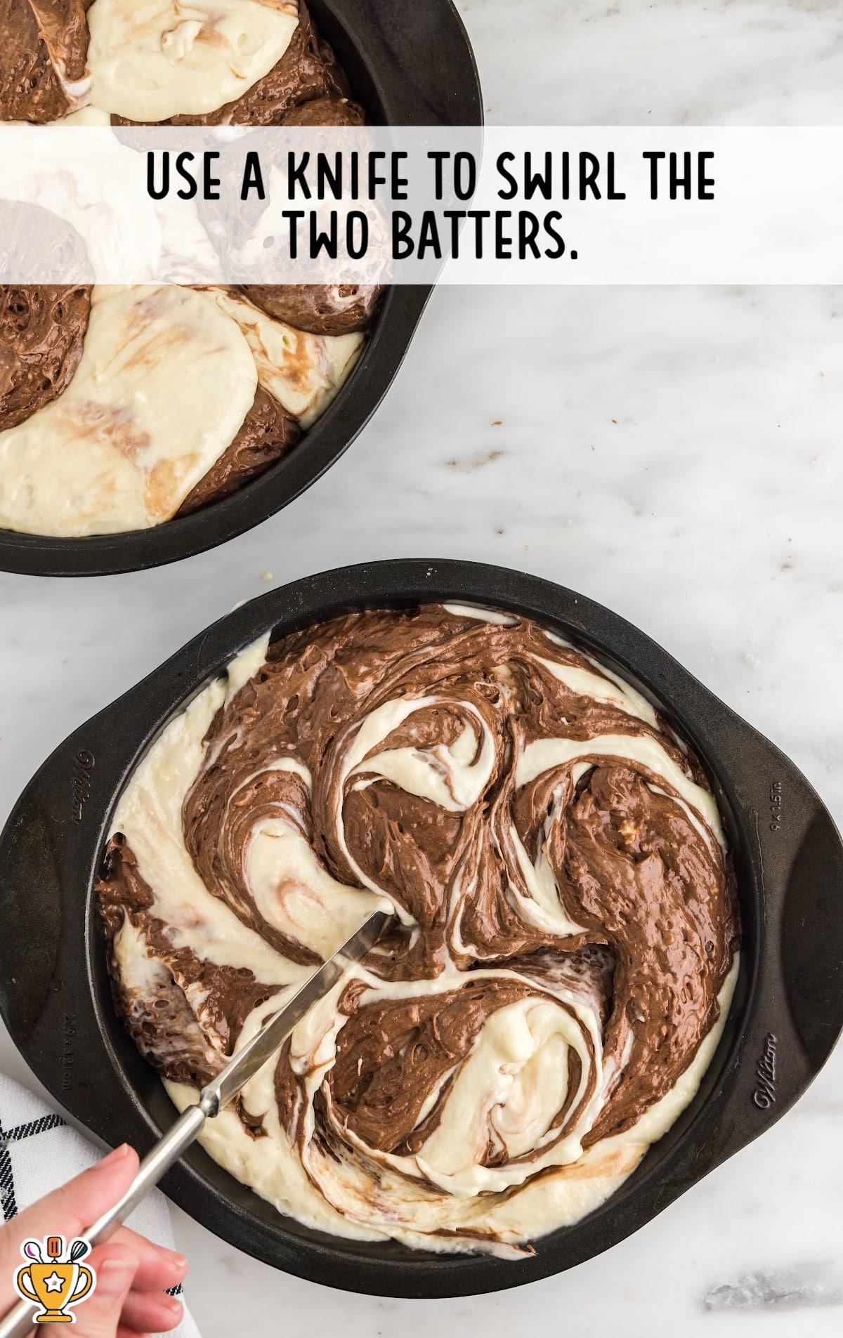 swirling the batters with a knife in a bowl