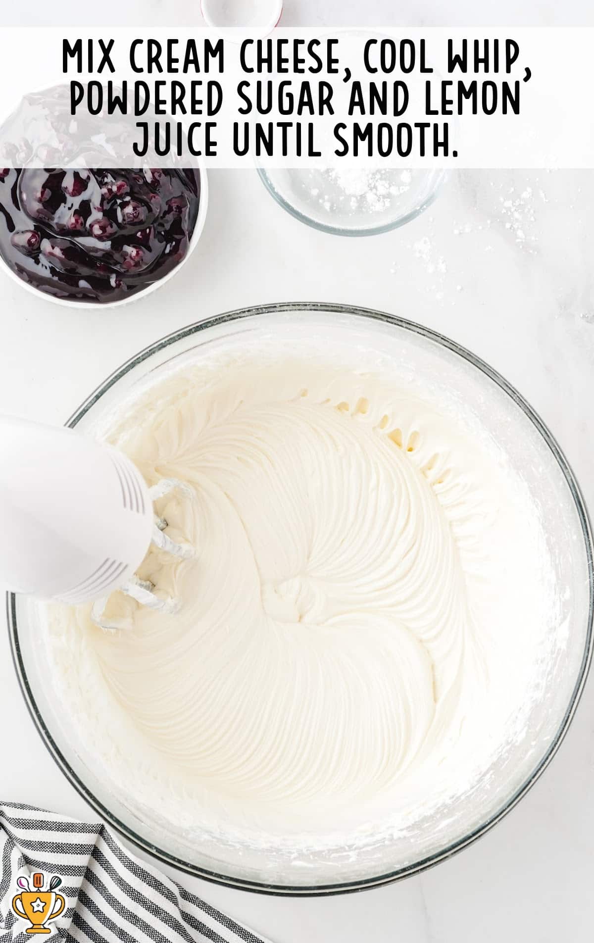 cream cheese, cool whip, powdered sugar and lemon juice mixed in a bowl