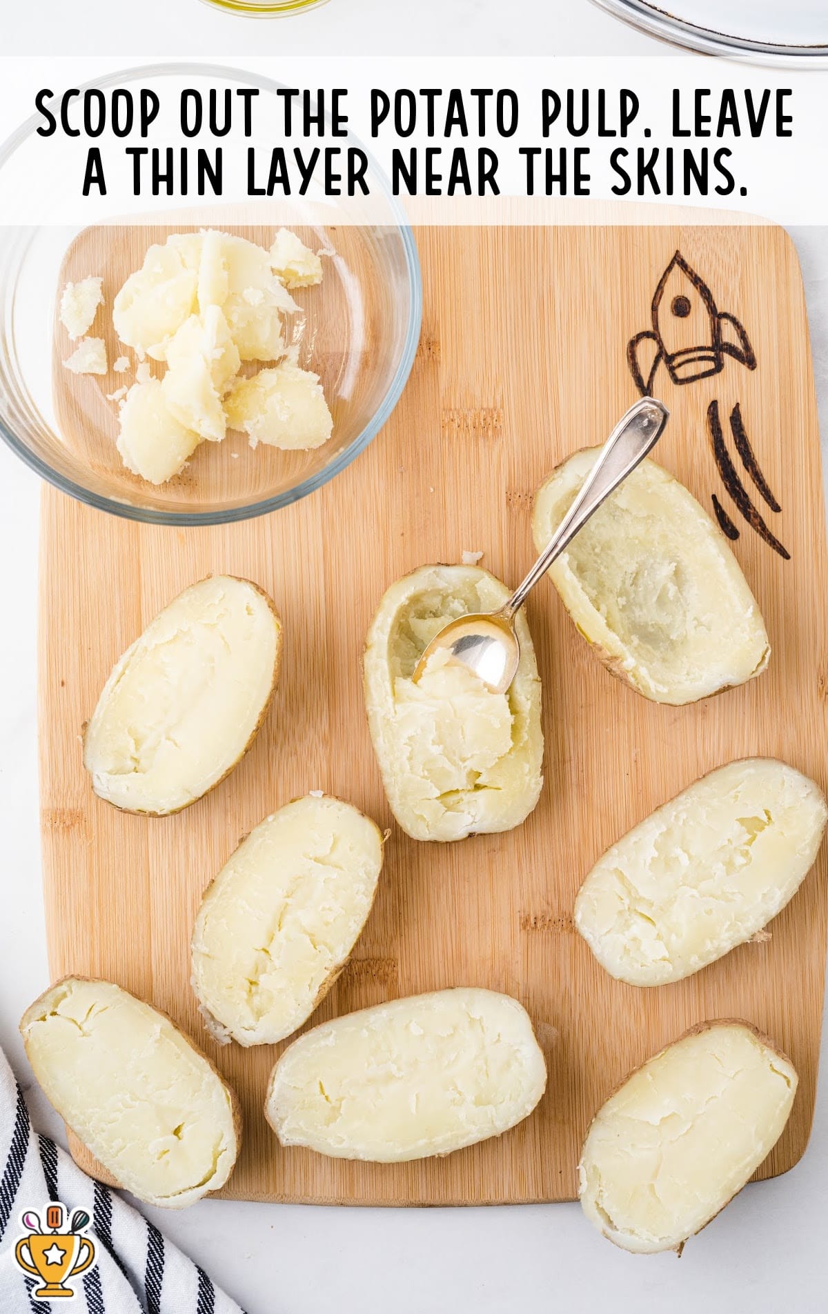 a spoon scooping out the potato pulp