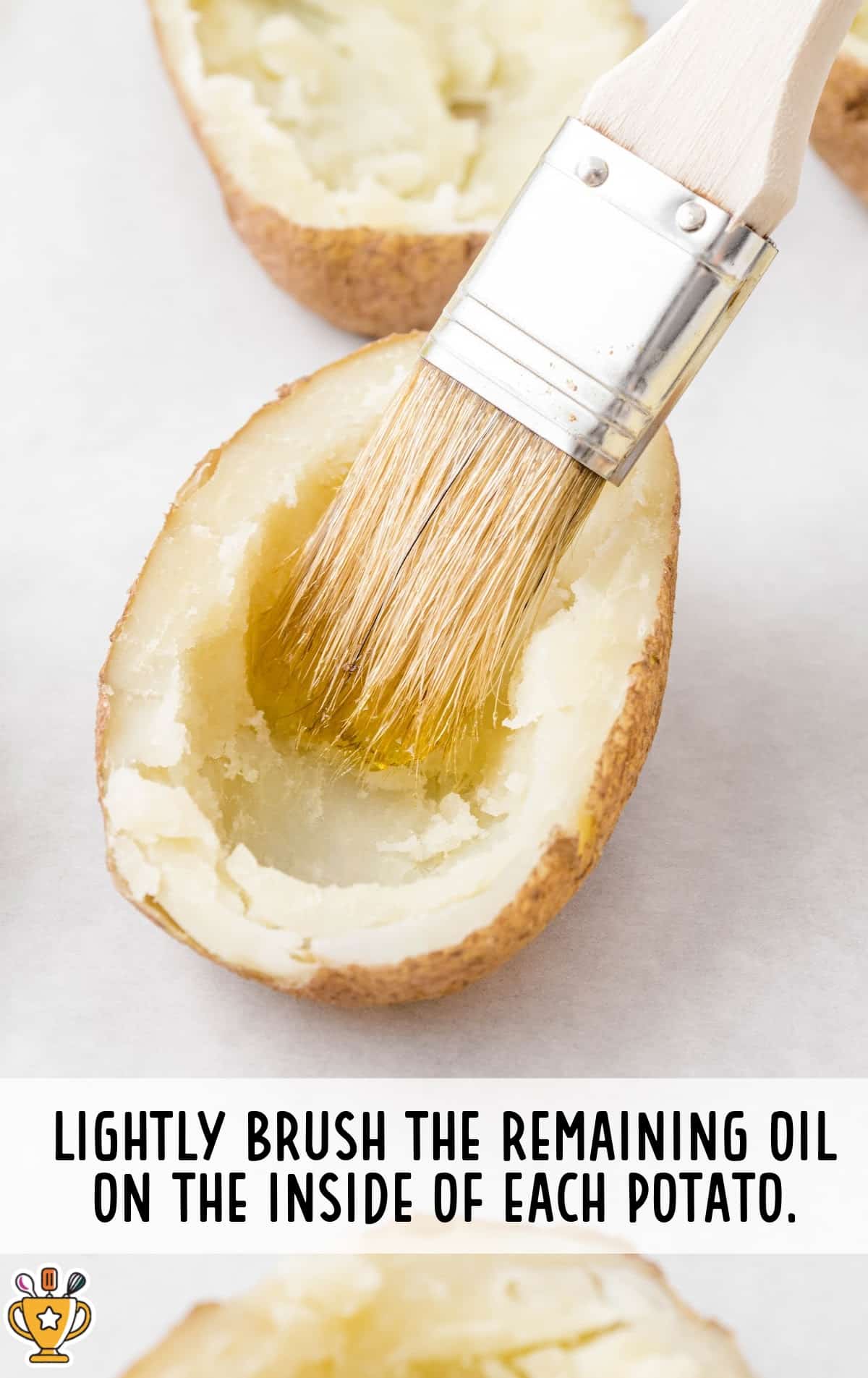 brushing the oil on the inside of a cut potato