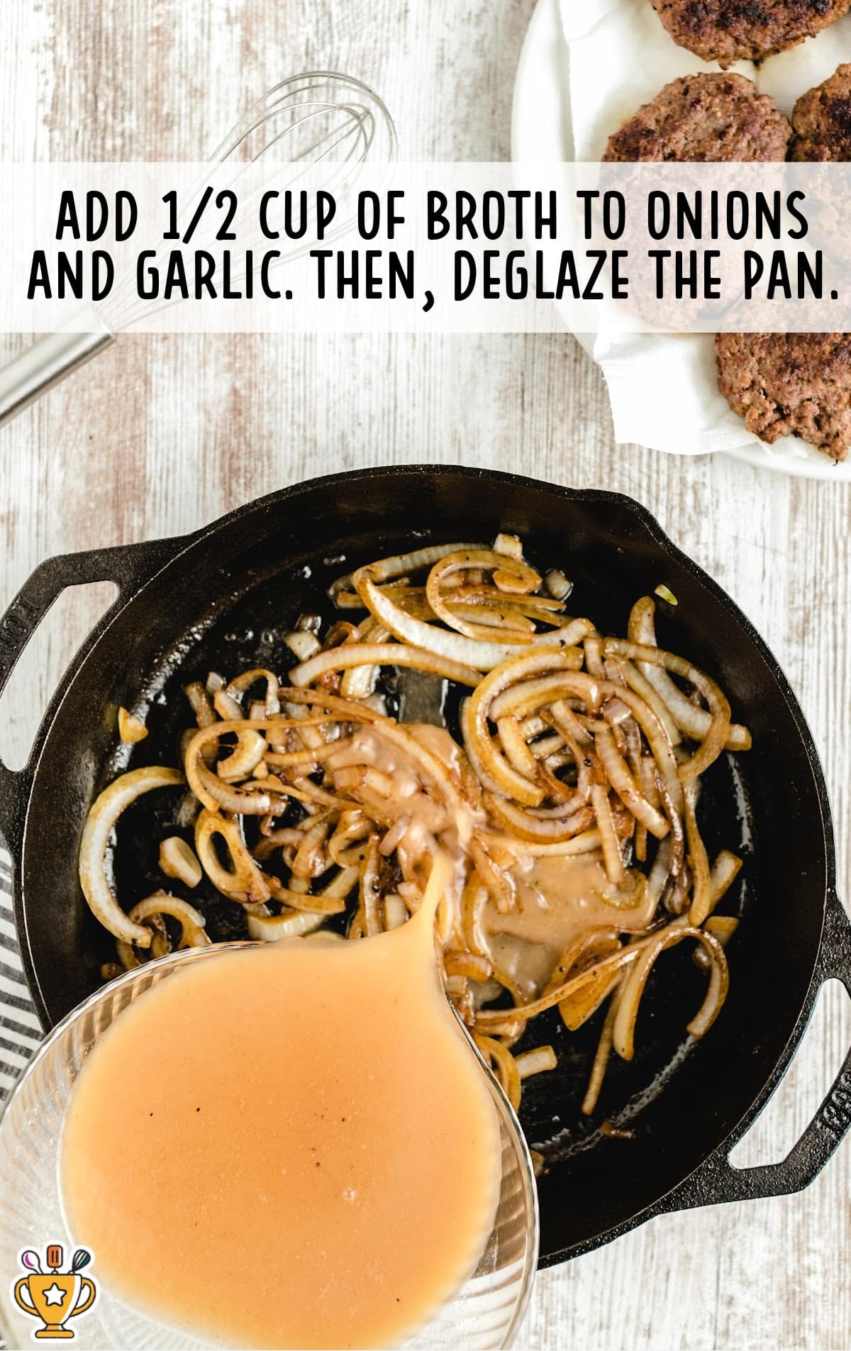 broth added to onion and garlic in a frying pan