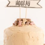 A dog birthday cake is on a platter.