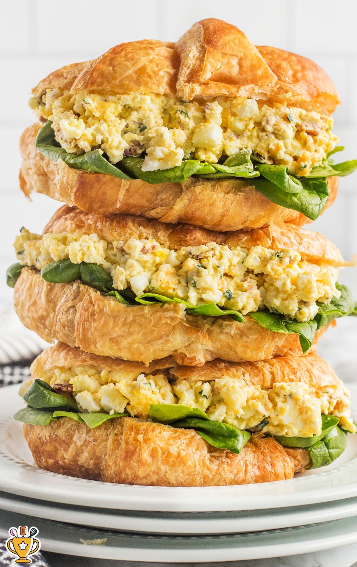 a stack of Egg Salad Sandwich on three plates
