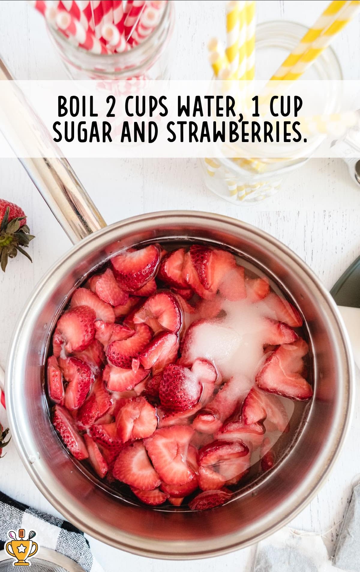 water, sugar and strawberries in a pan