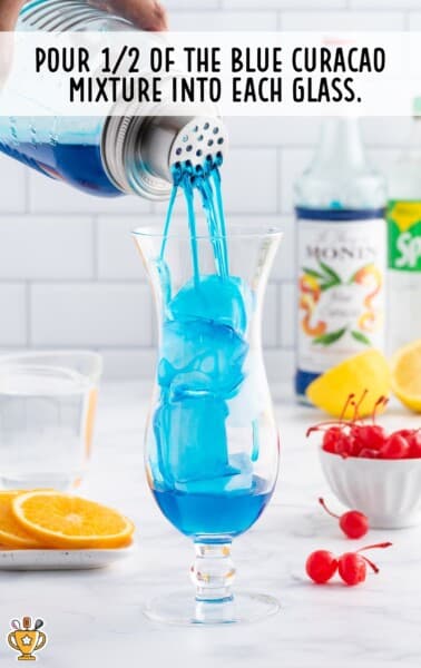 pouring blue curacao mixture in a glass