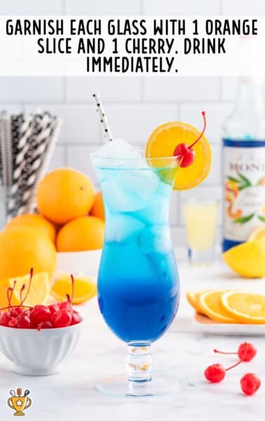 a glass of Blue Mocktail with a straw in it