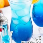 a glass of Blue Mocktail with a straw in it