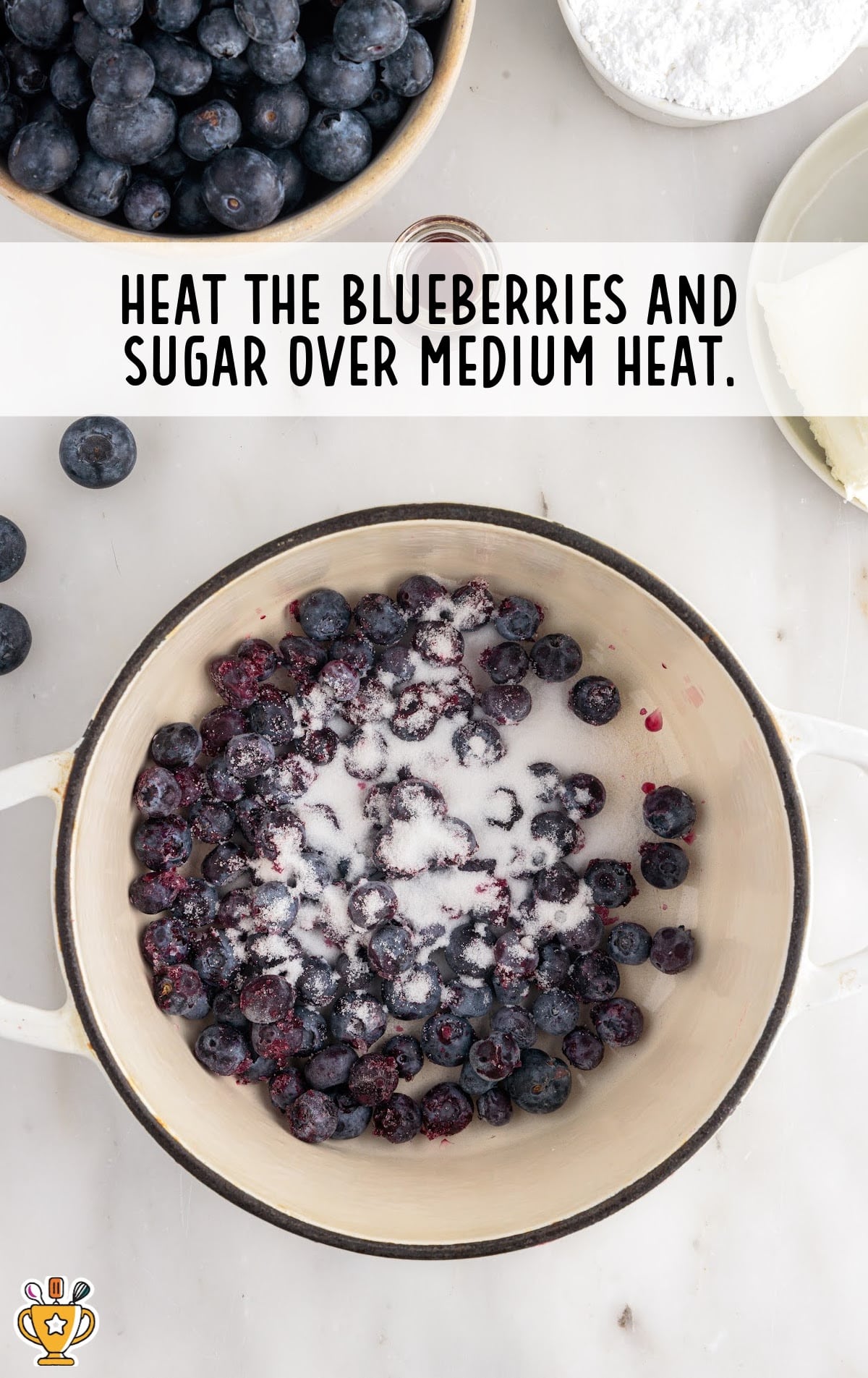 heating the blueberries and sugar in a pan over a medium heat