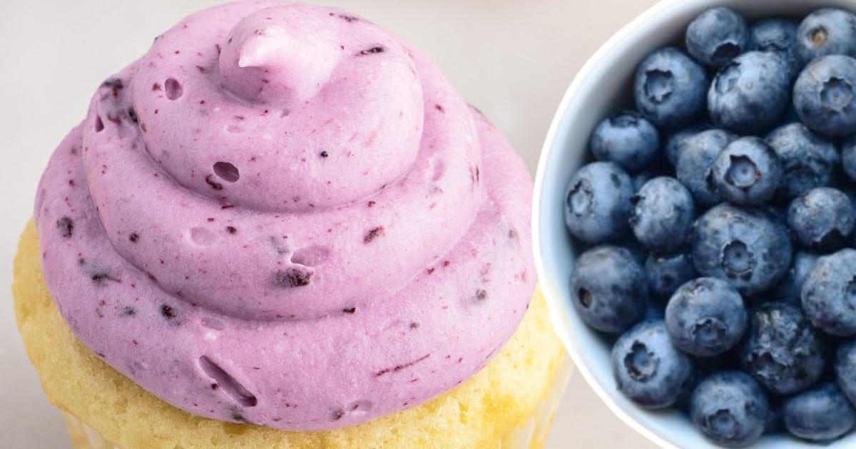 Blueberry Cream Cheese Frosting on a cupcake and some Blueberries in a bowl